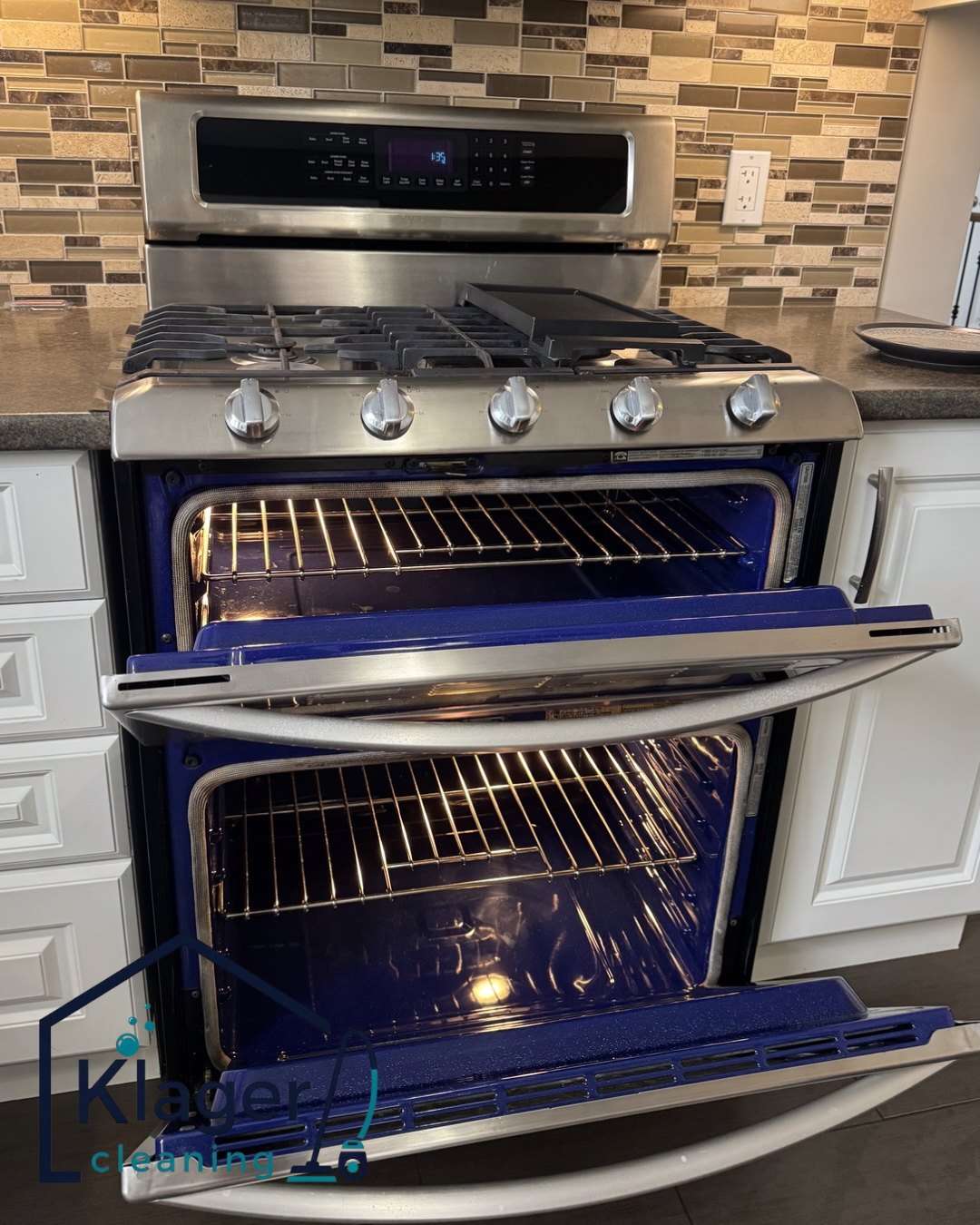 Clean double oven with blue enamel interiors and polished stainless-steel stove